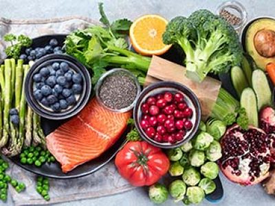 Healthy food selection on gray background. Detox and clean diet concept. Foods high in vitamins, minerals and antioxidants. Anti age foods. Top view