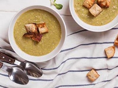 Broccoli cream soup in a bowl with crispy bread. Go green concept.